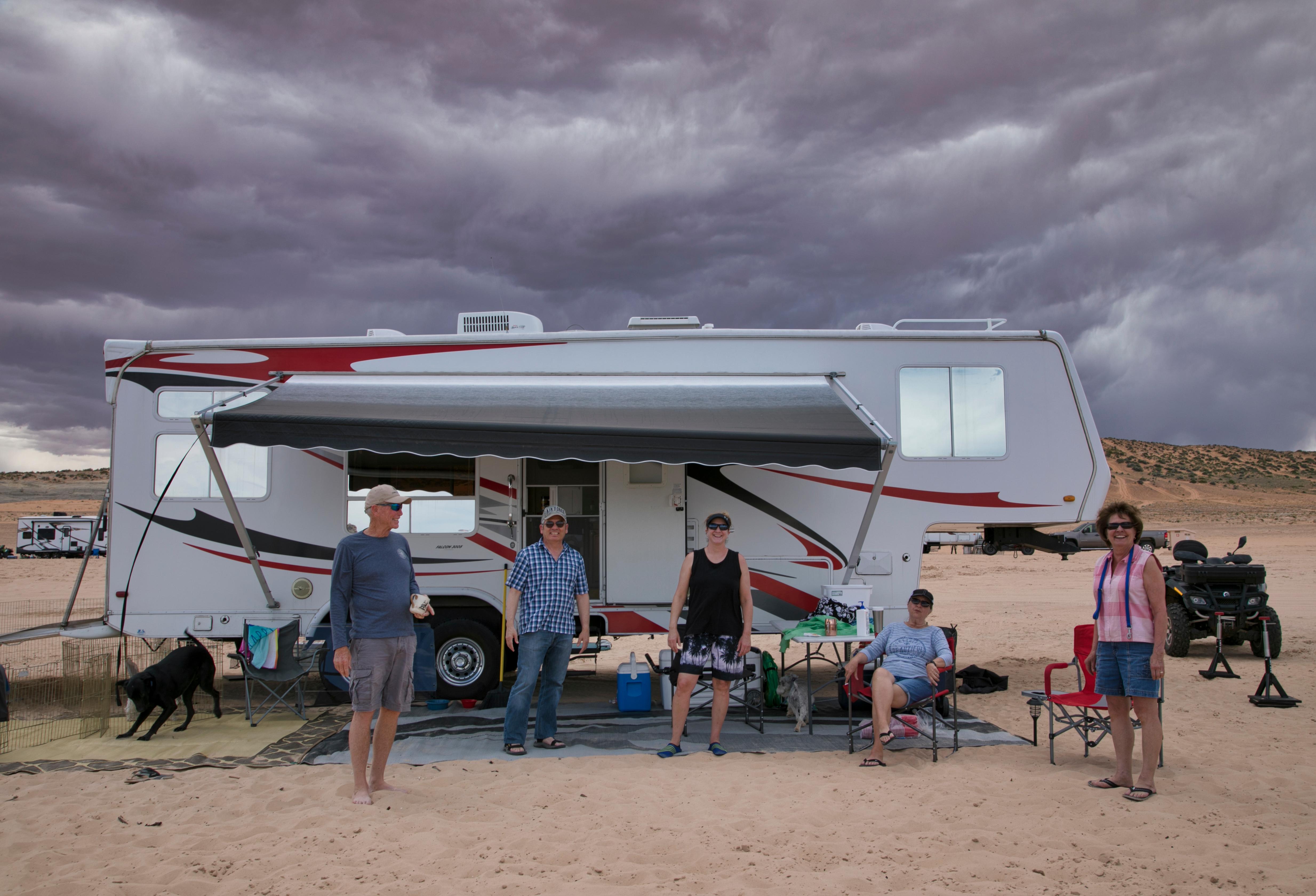RV with group of people smiling in front
