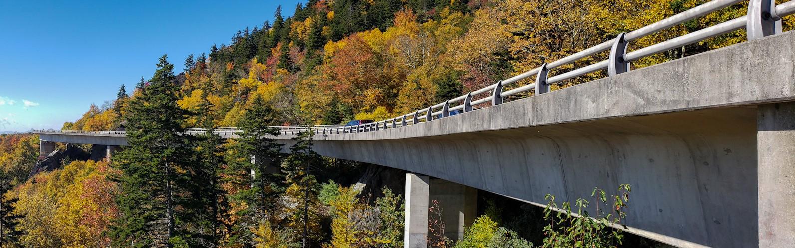 A concrete viaduct hugs the side of a mountain