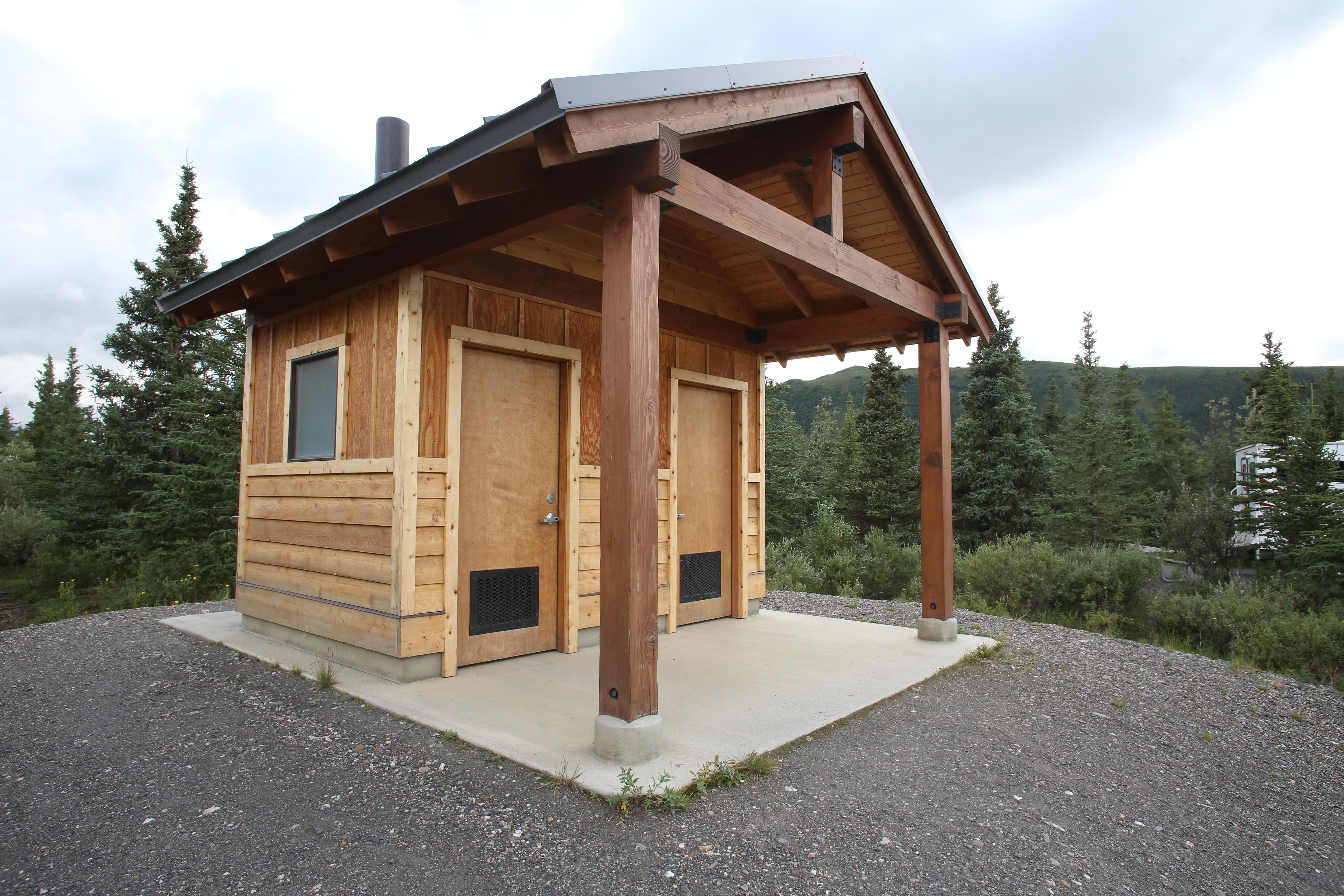a small wooden building with two doors