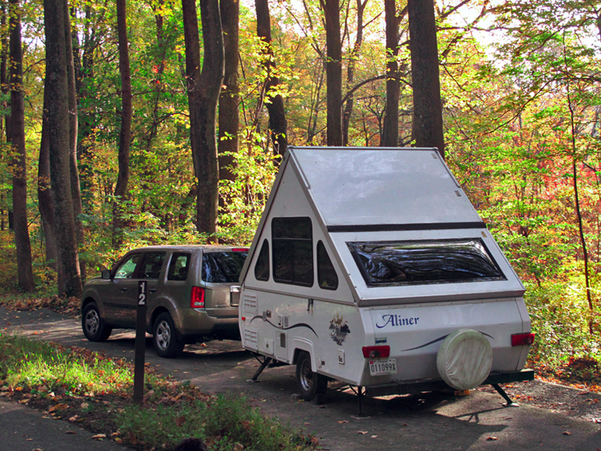 Popup camper in wooded campground