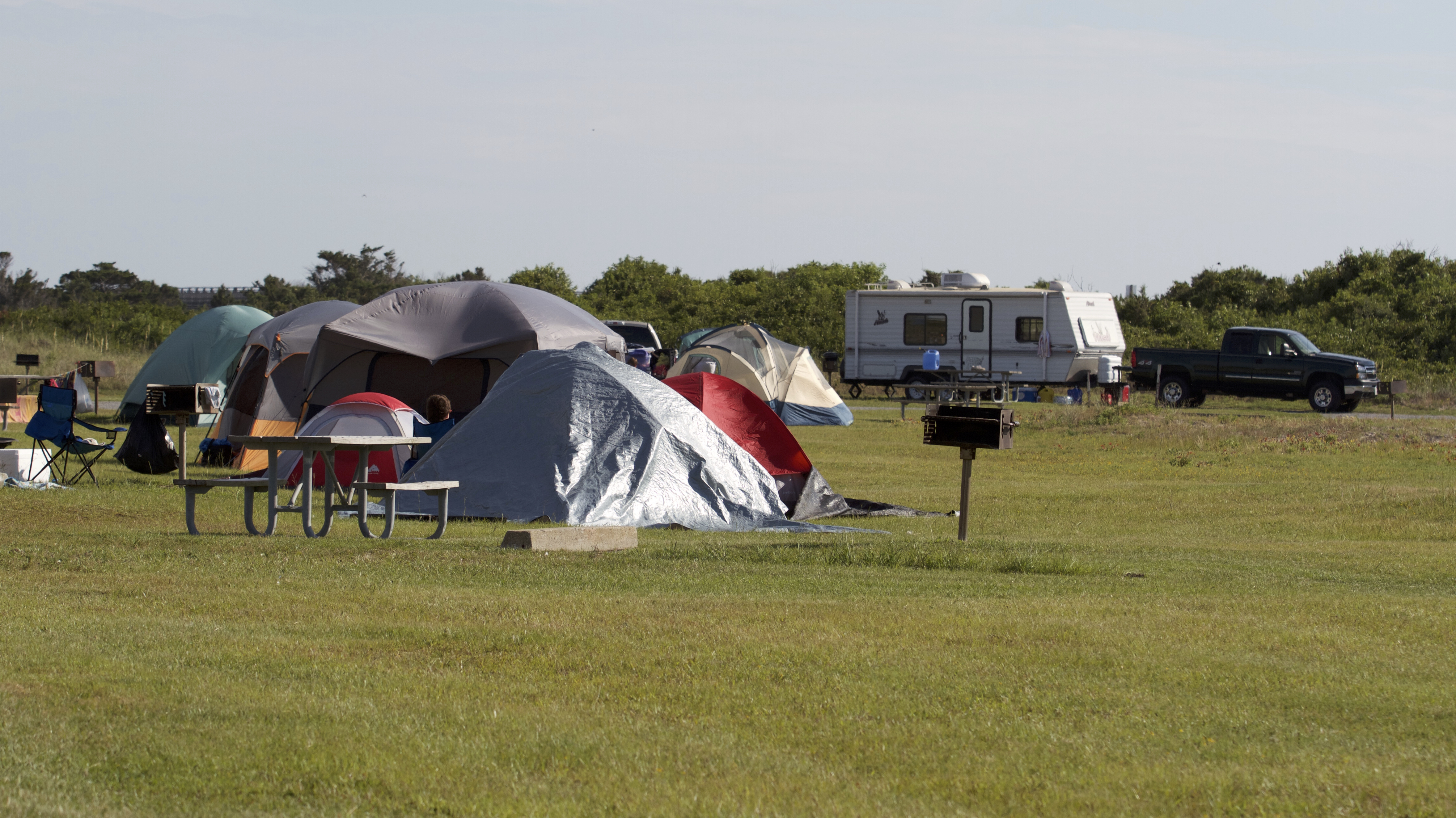 Tents and a camper at the Oregon Inlet Campground.