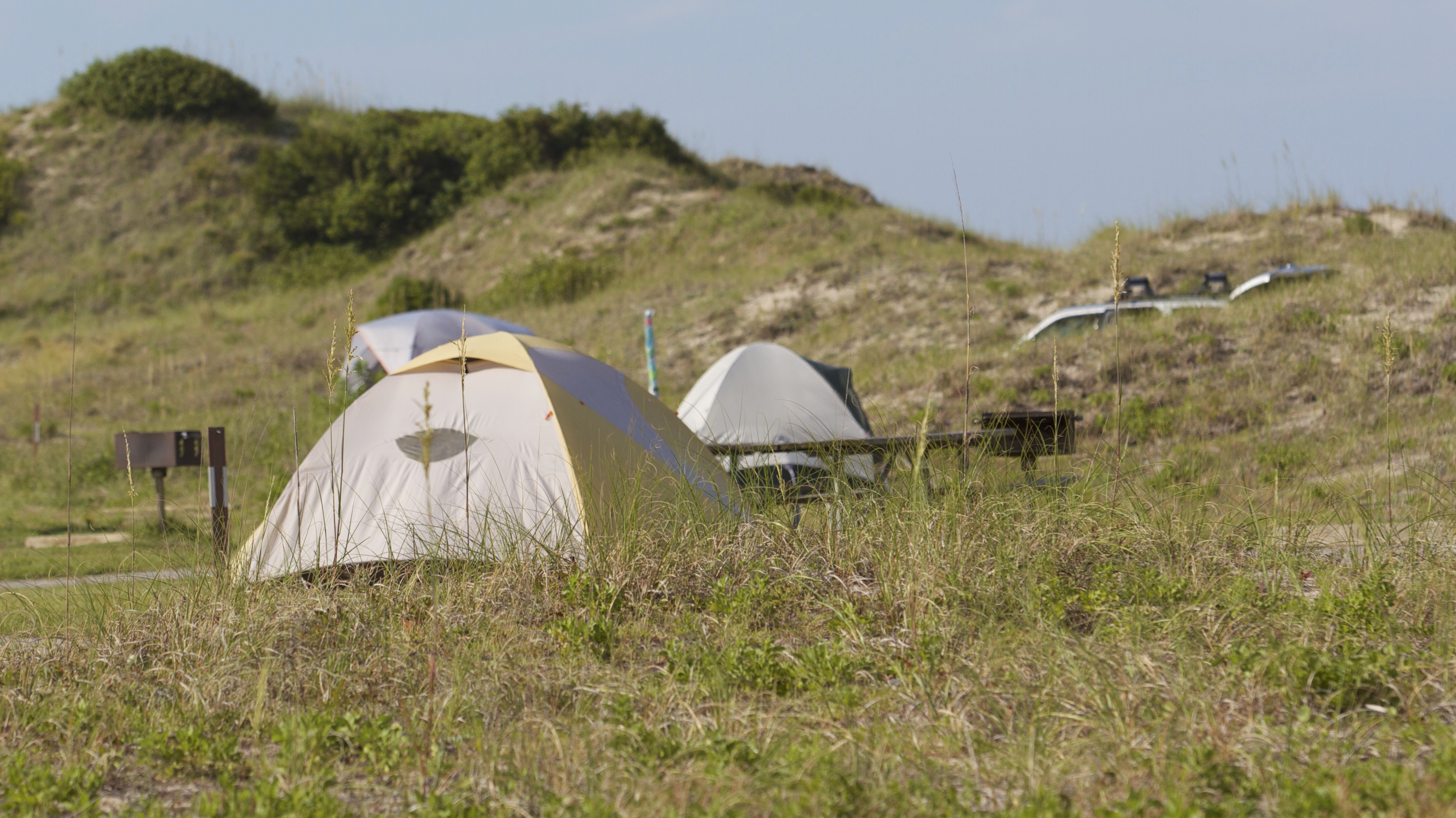 Tents nestled in next to the dunes at Oregon Inlet Campground.