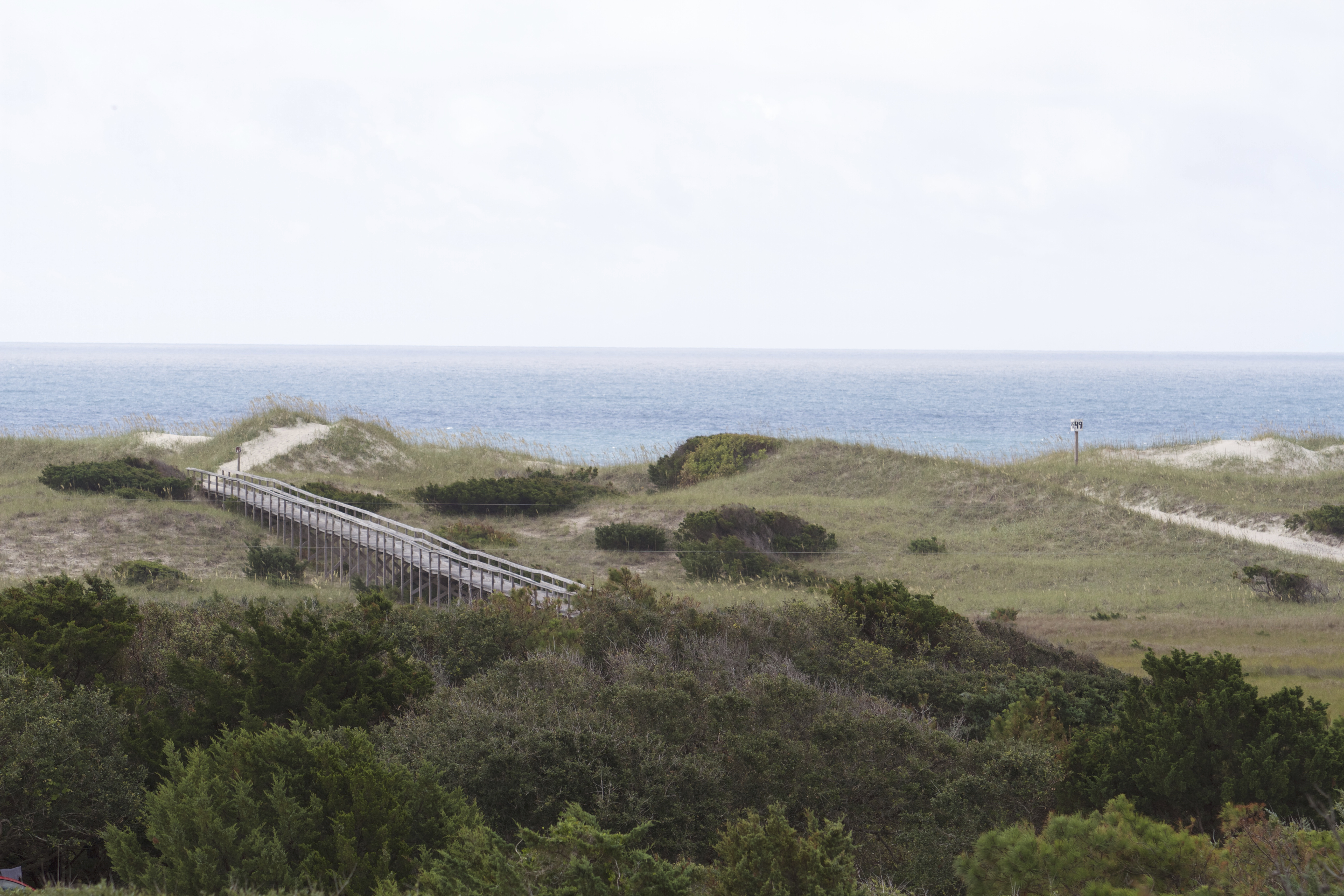 WIthin the dunes, a wooden boardwalk and sandy off-road vehicle ramp both lead to the beach.