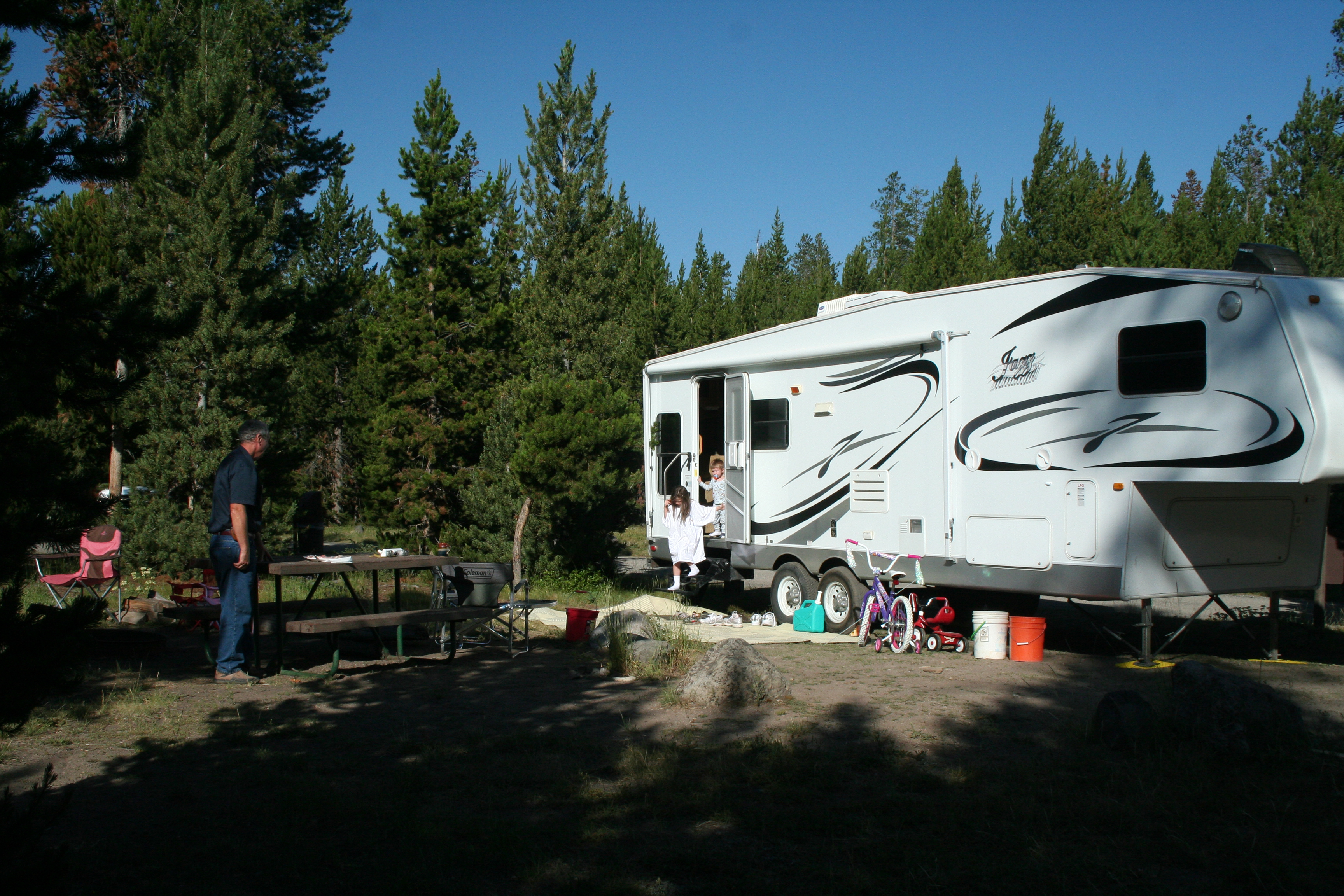 RV and people at a campsite