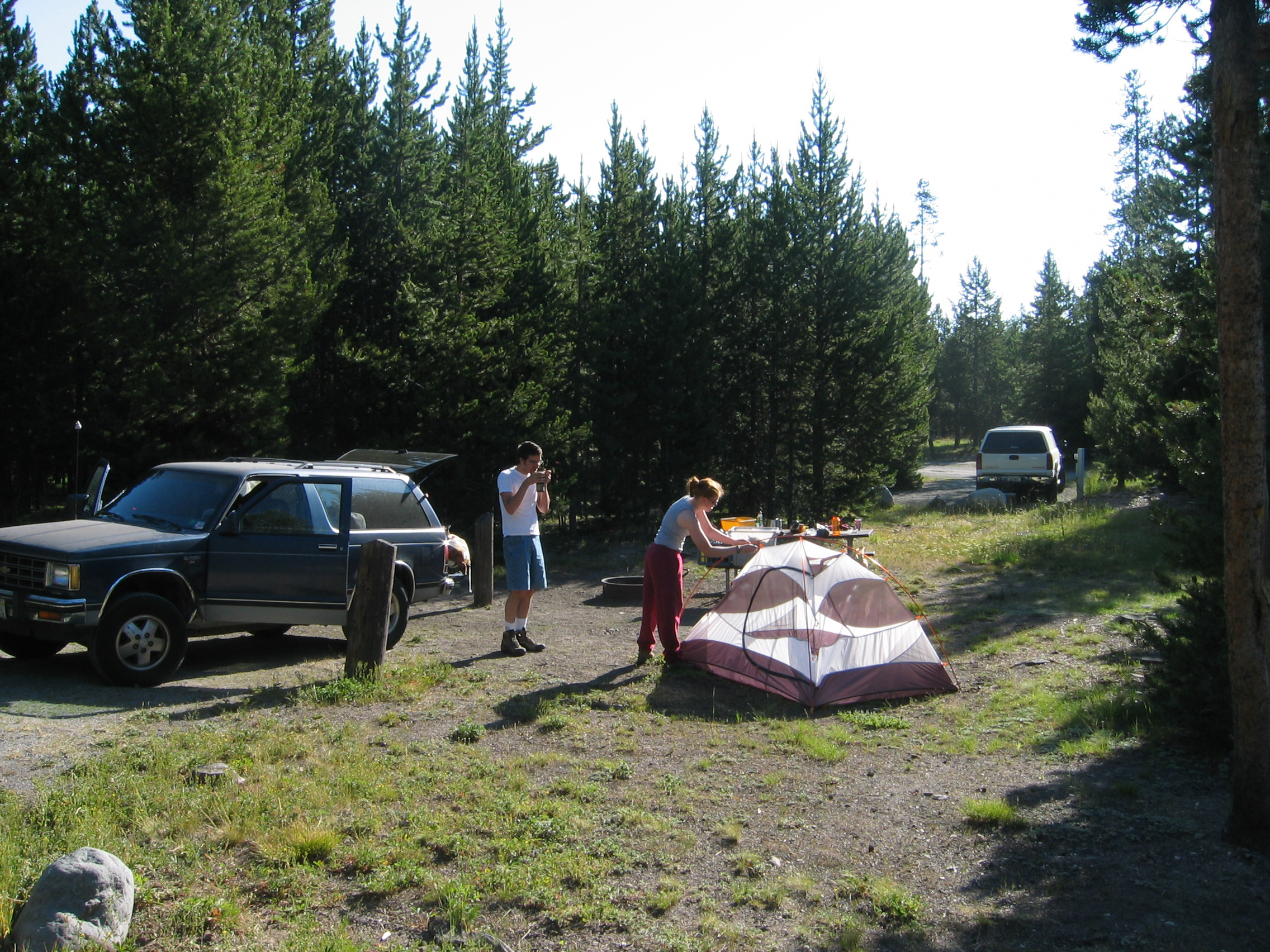 Visitors setting up tent at campsite.