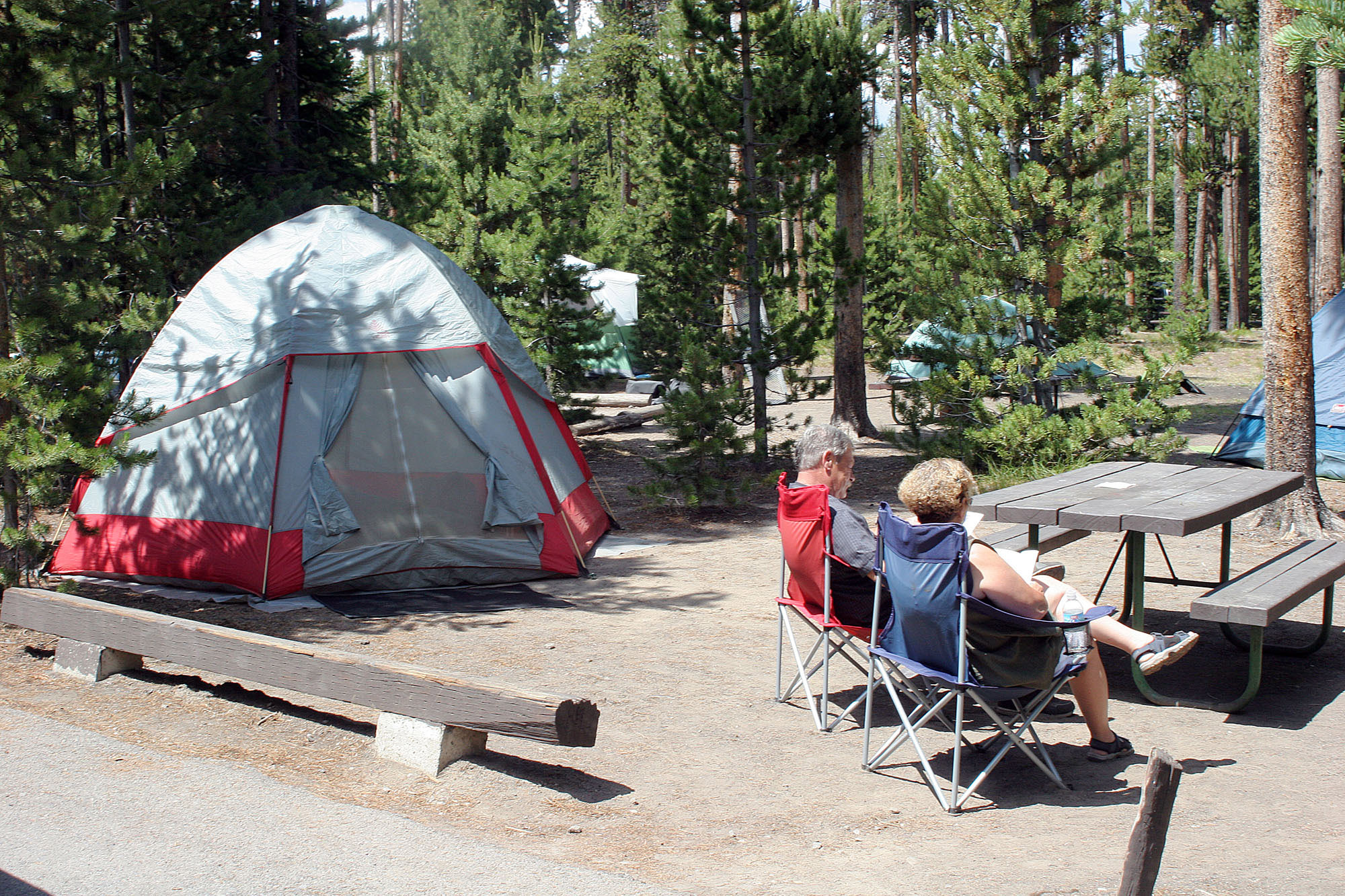 Tent and campers at campsite.