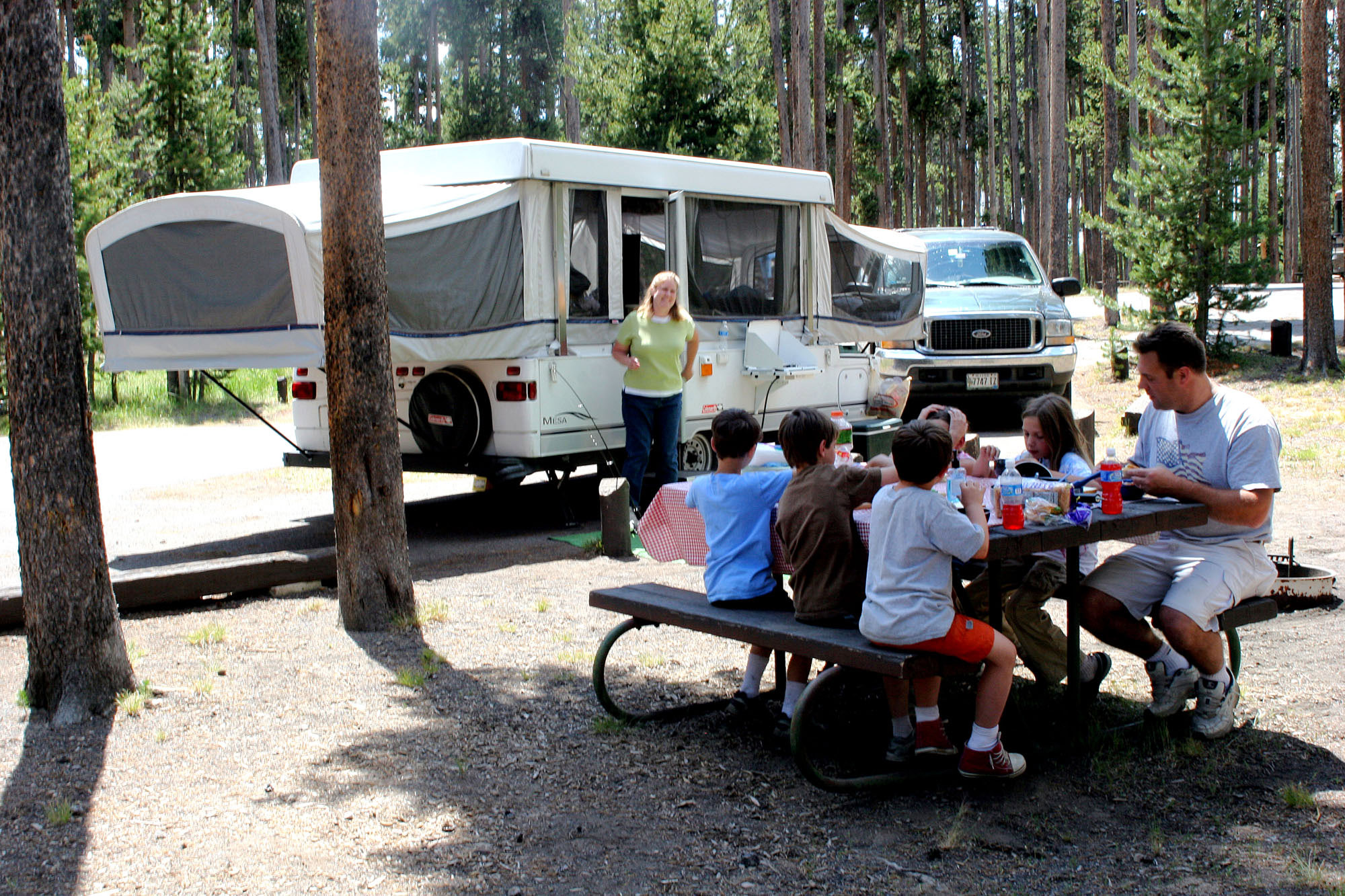 Family picnicking at campsite.