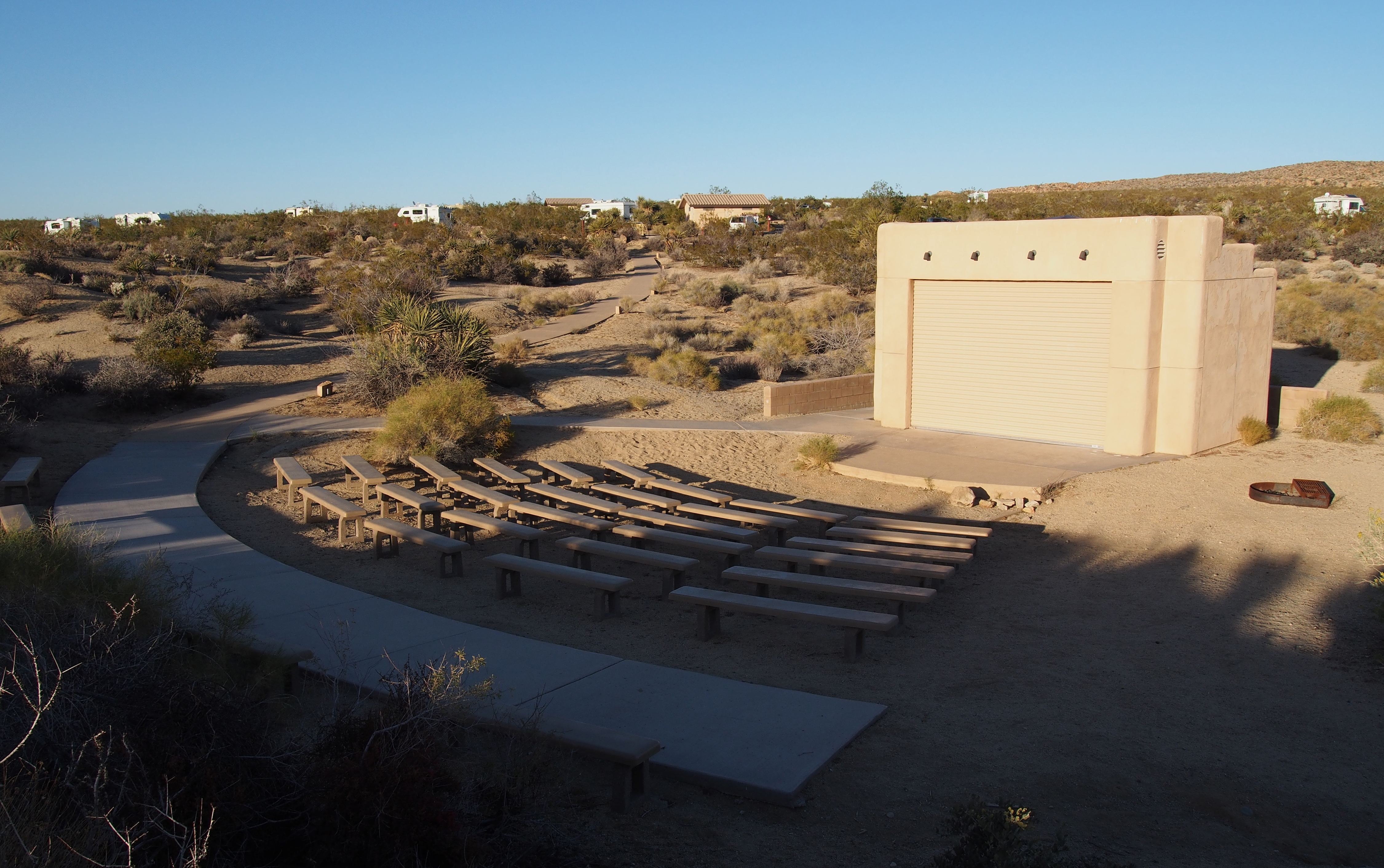 Rows of seats are in front of an outdoor stage.
