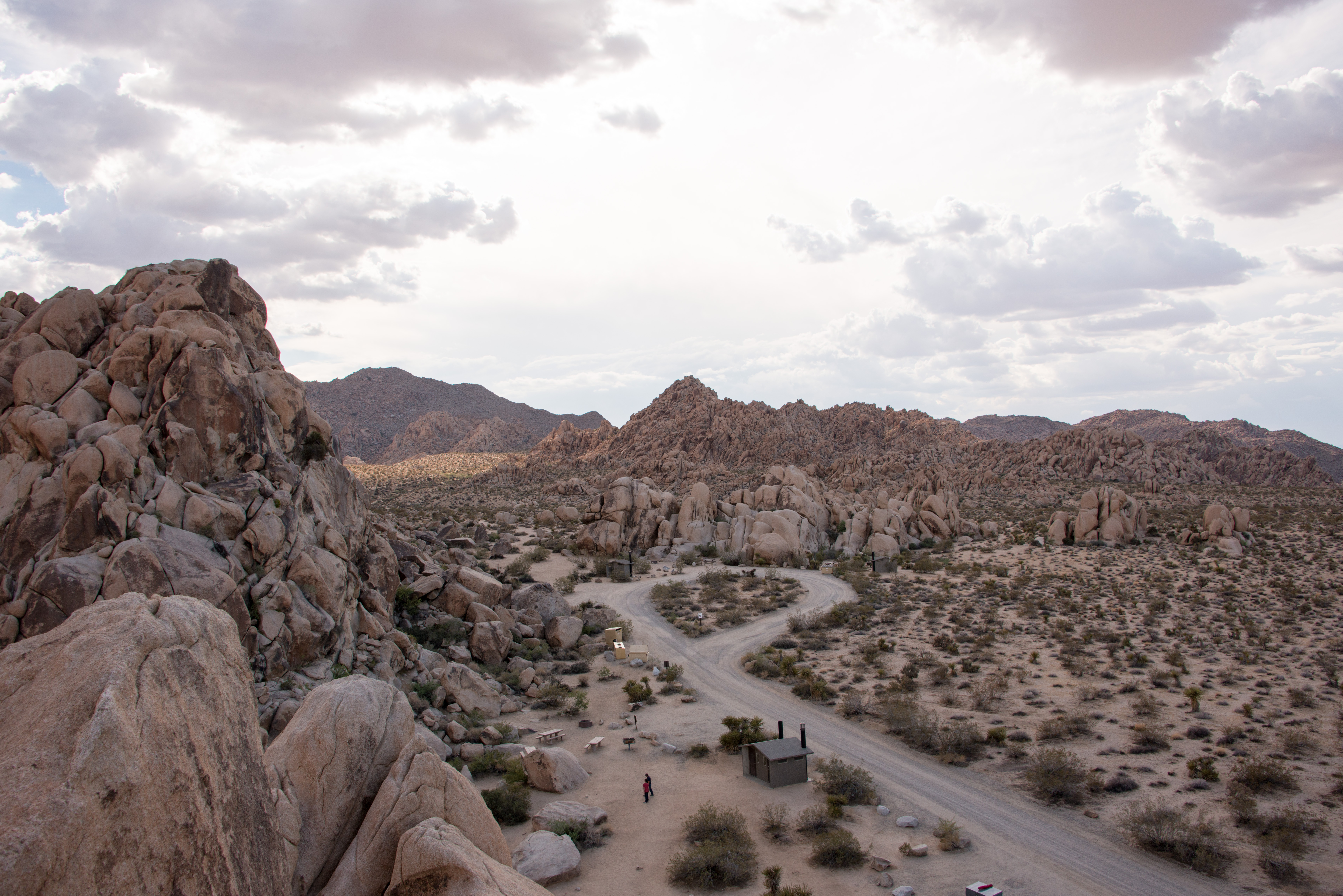 Looking down on Indian Cove Campground with the road, a vault toilet and campsites.