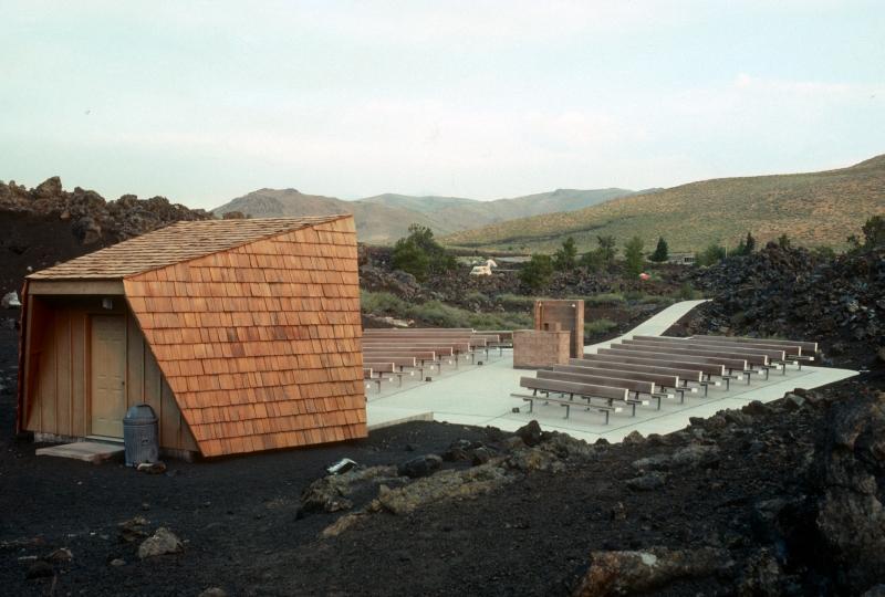 an amphitheater with benches, projection counter, and a roofed stage