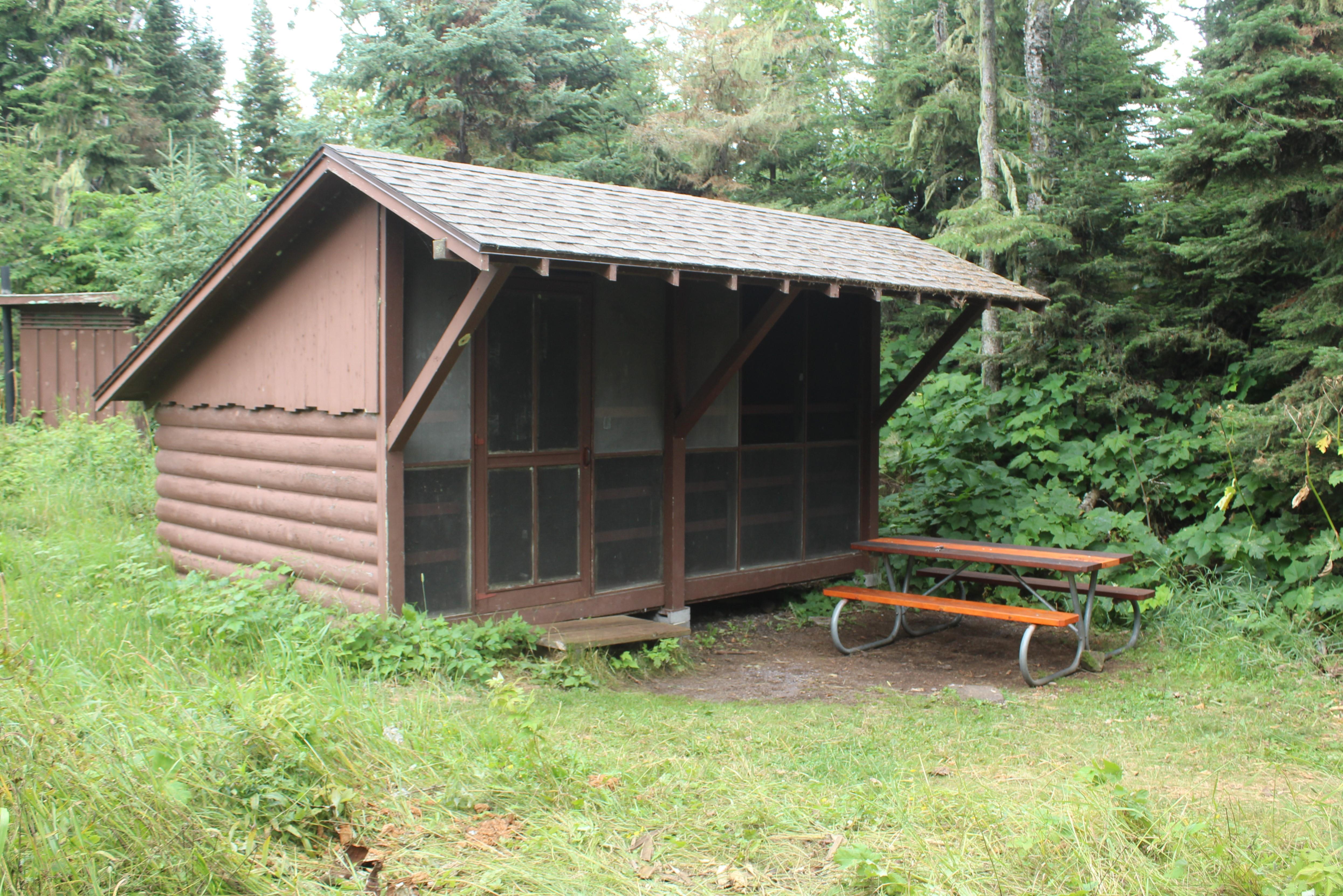 Campground shelter with picnic table.