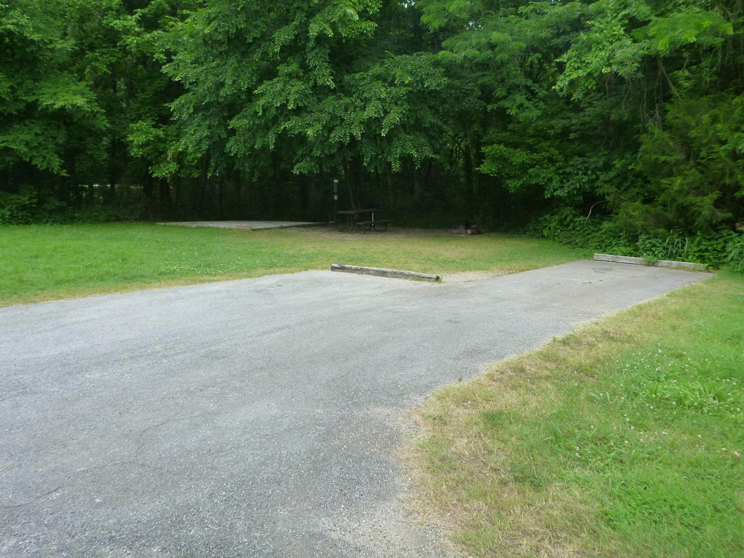 A paved camp site surrounded by grass at Tyler Bend Campground.