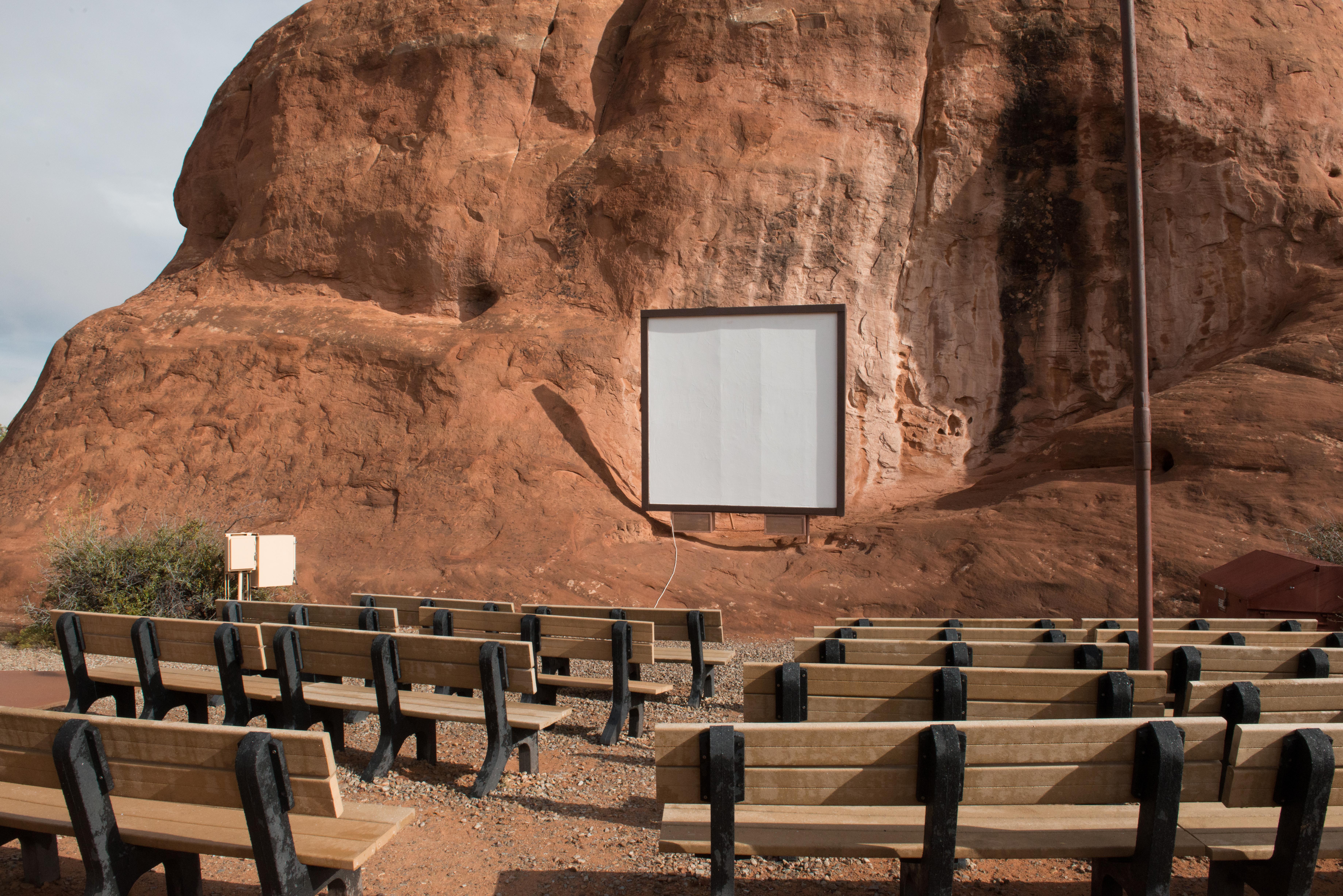 an amphitheater with benches and a screen