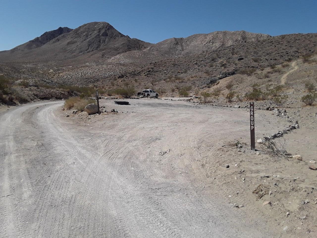 Large parking and tent area for groups with mountain view.