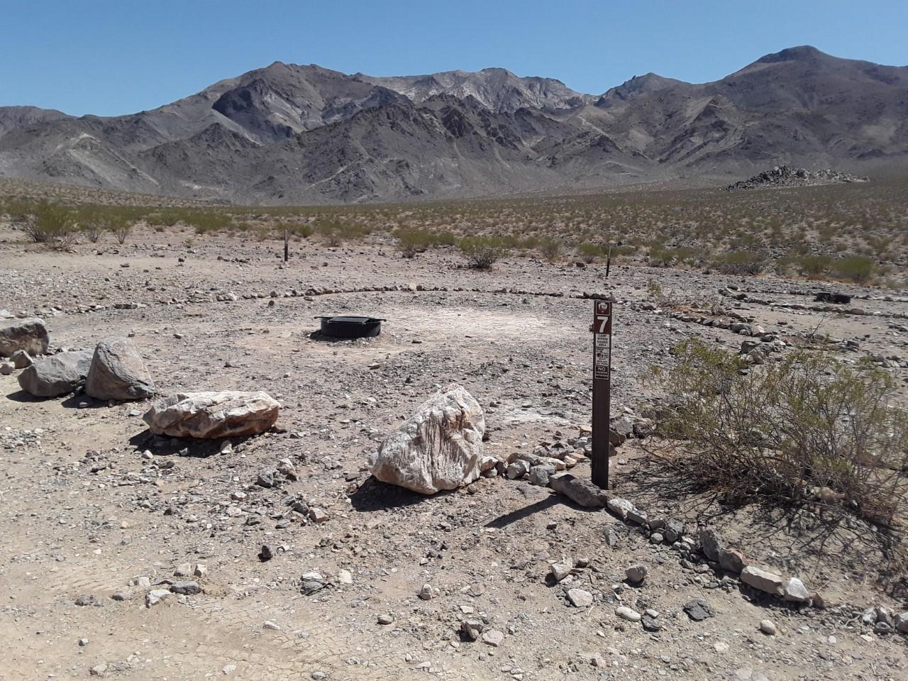View of the mountains from unpaved road.  Fire rings are provided at each campsite.