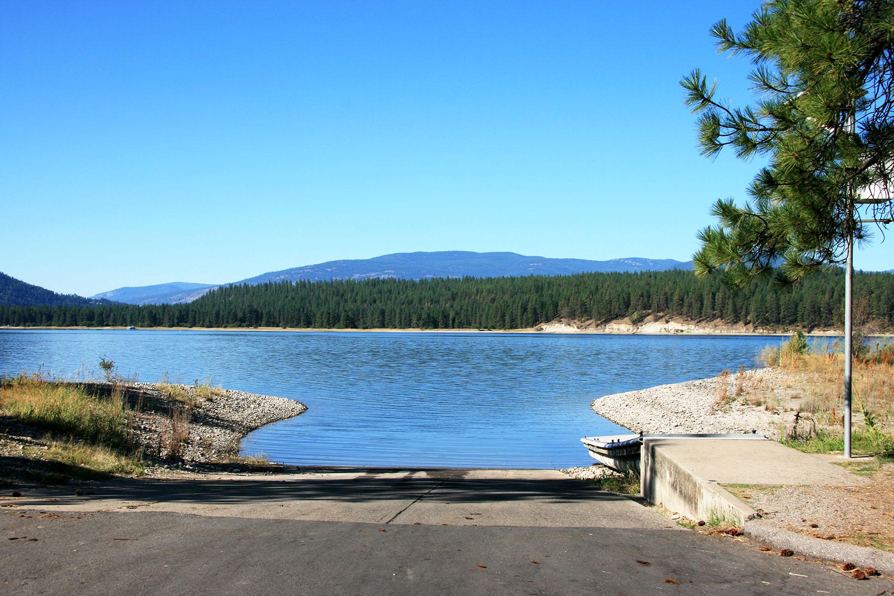 boat launch leading into blue lake water