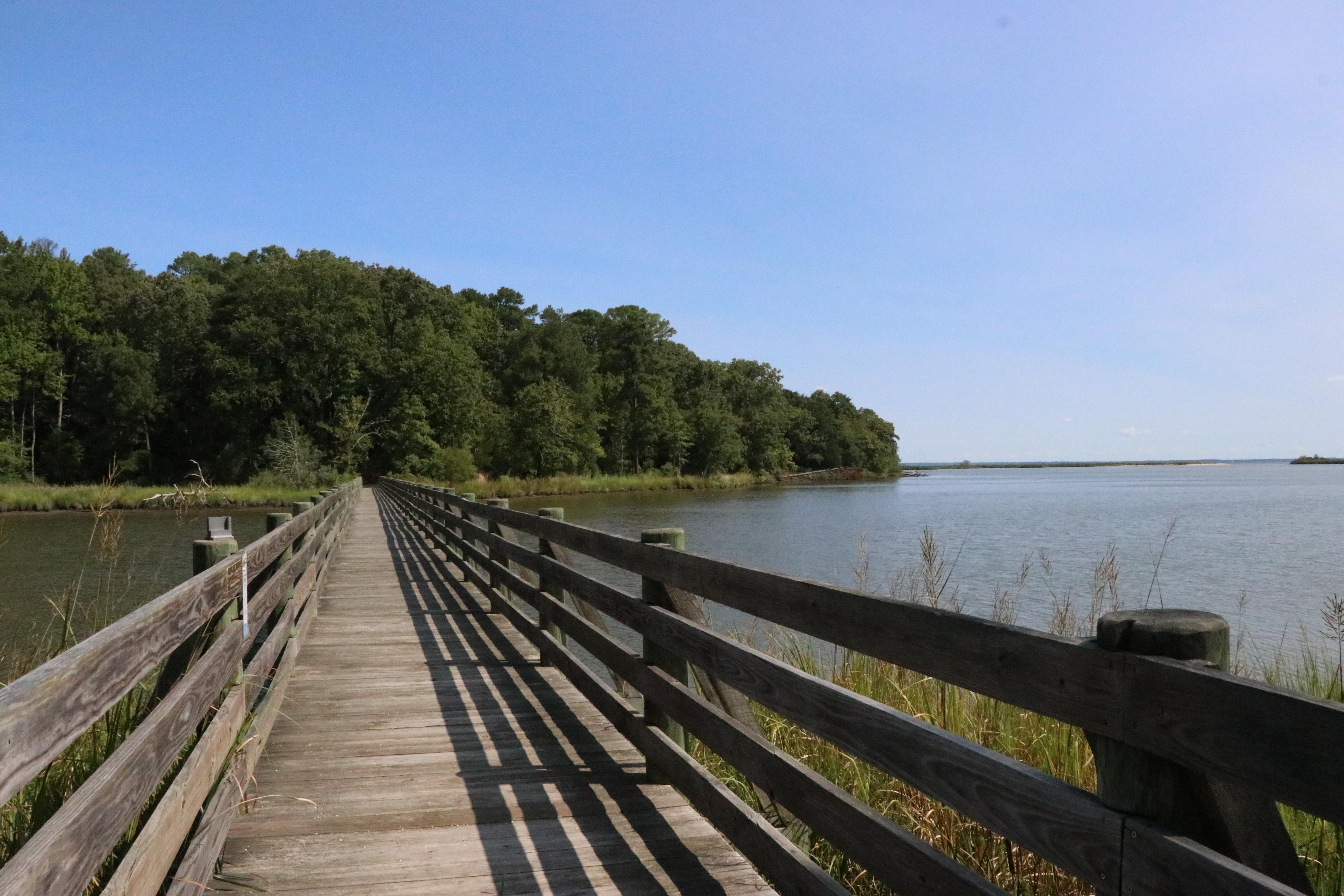 A wooden bridge stretching from shore to shore over a large body of water