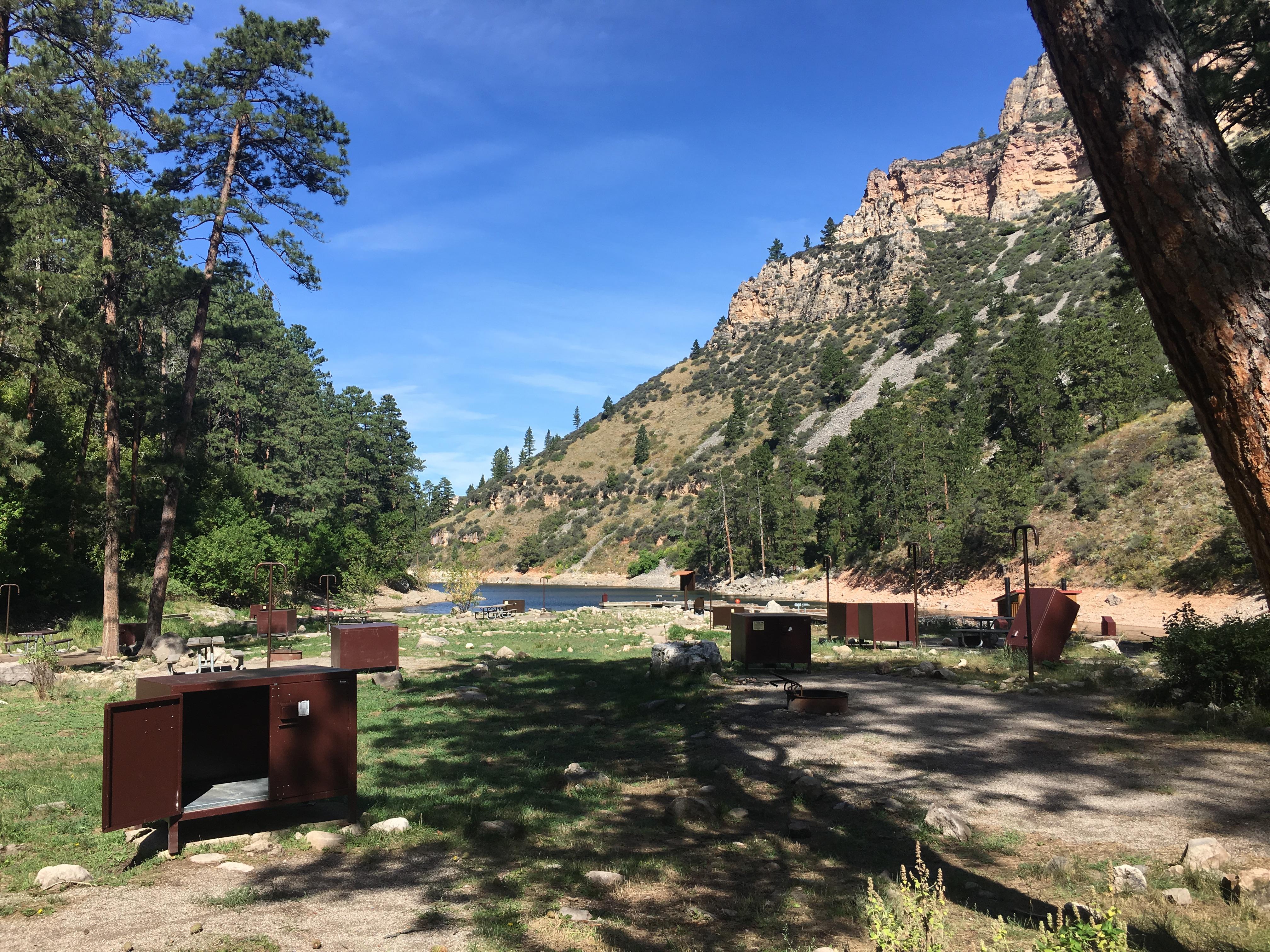 Several primitive tent sites in the foreground with the lake and canyon in the background.