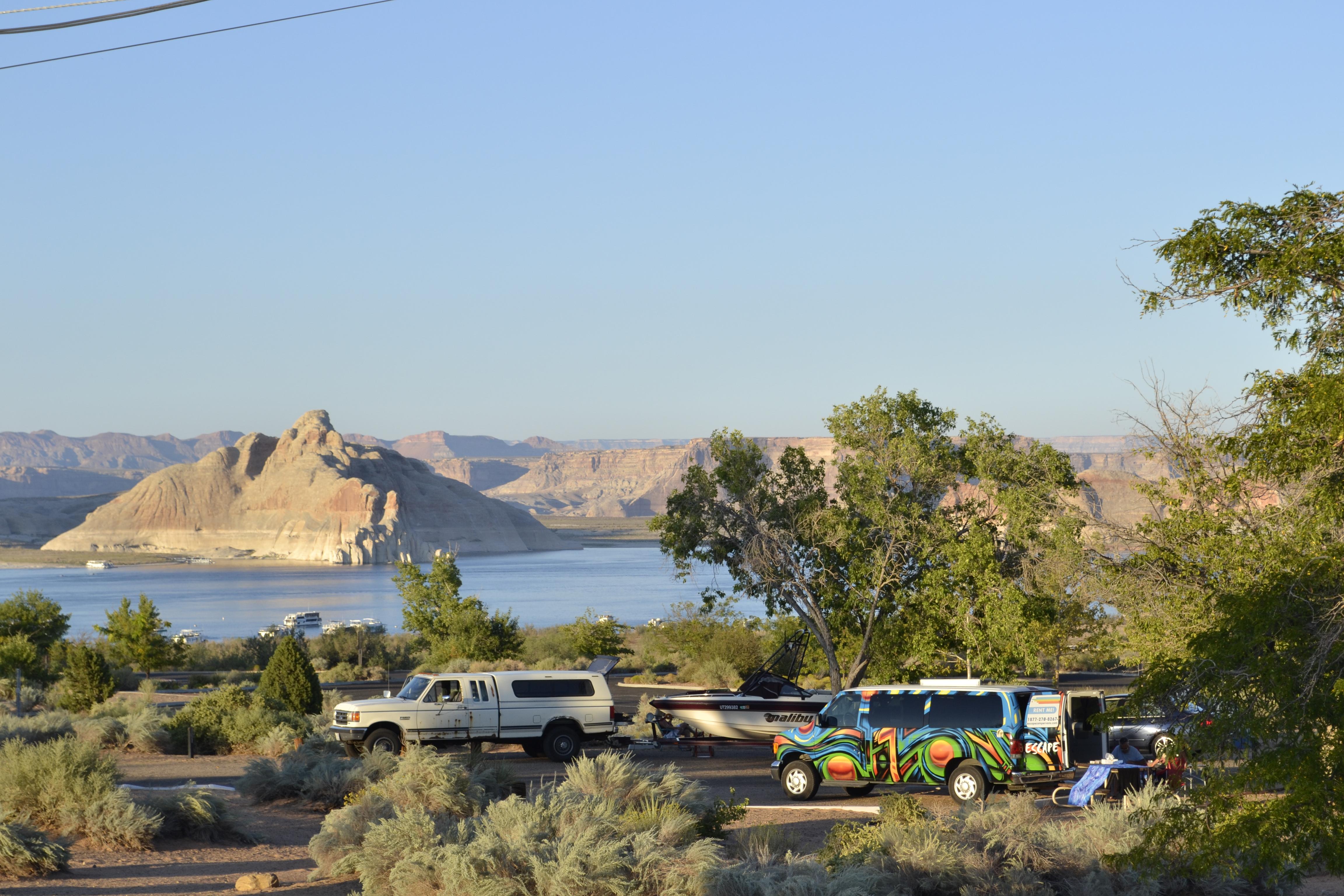 Colorful van, truck towing a boat. lake Powell in background.