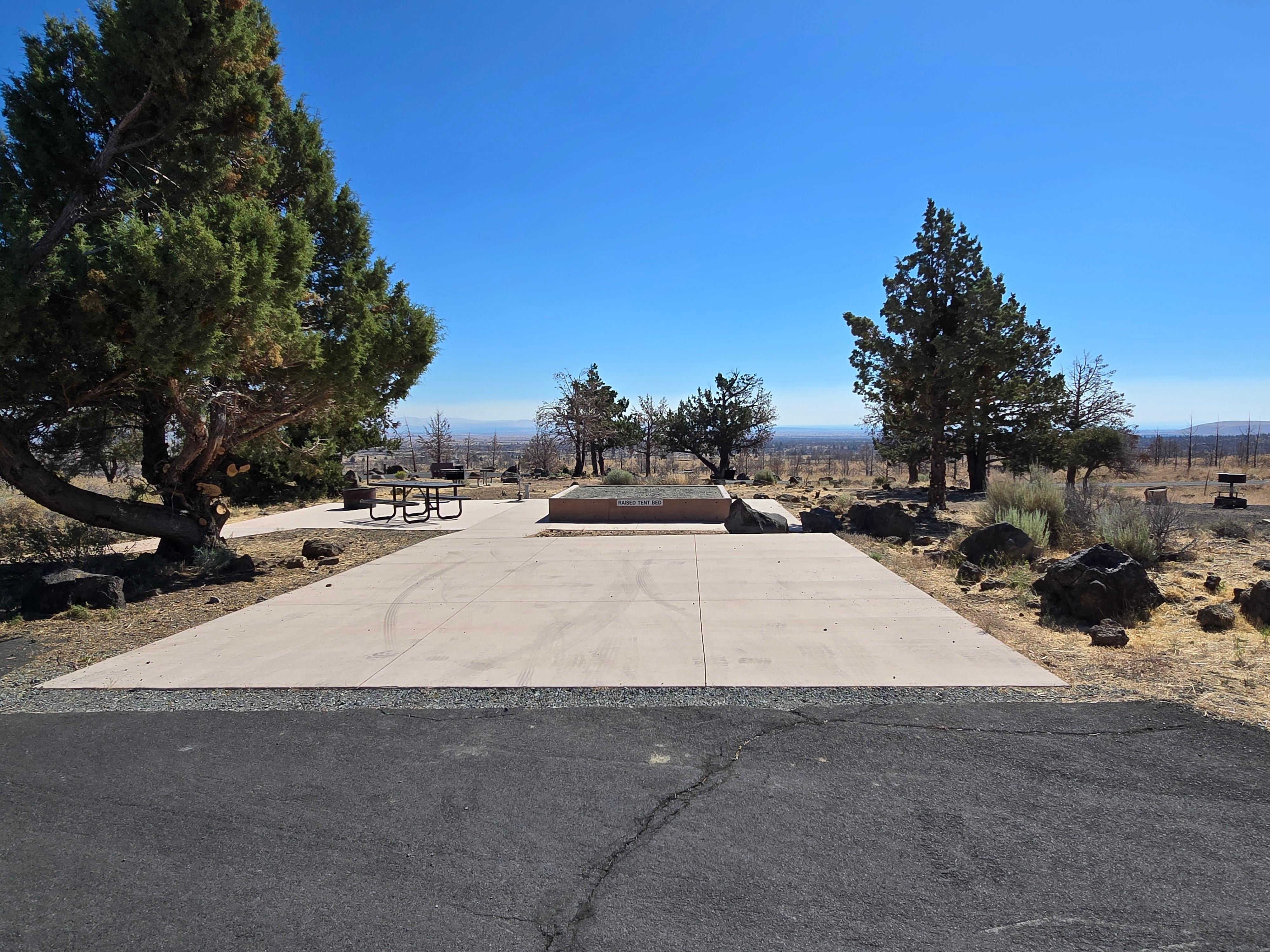 paved campsite with raised platform for tents
