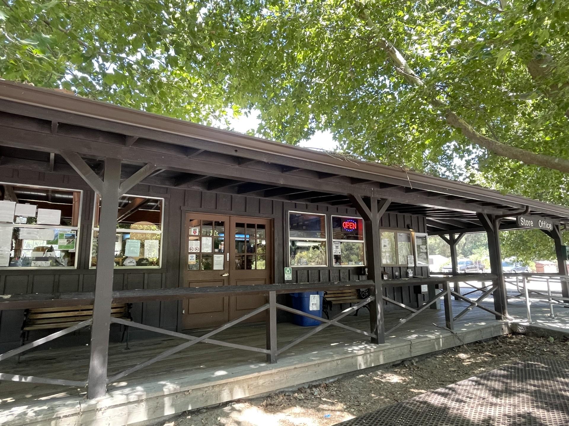 View of a ramp to a wooden wrap around deck of a wooden building