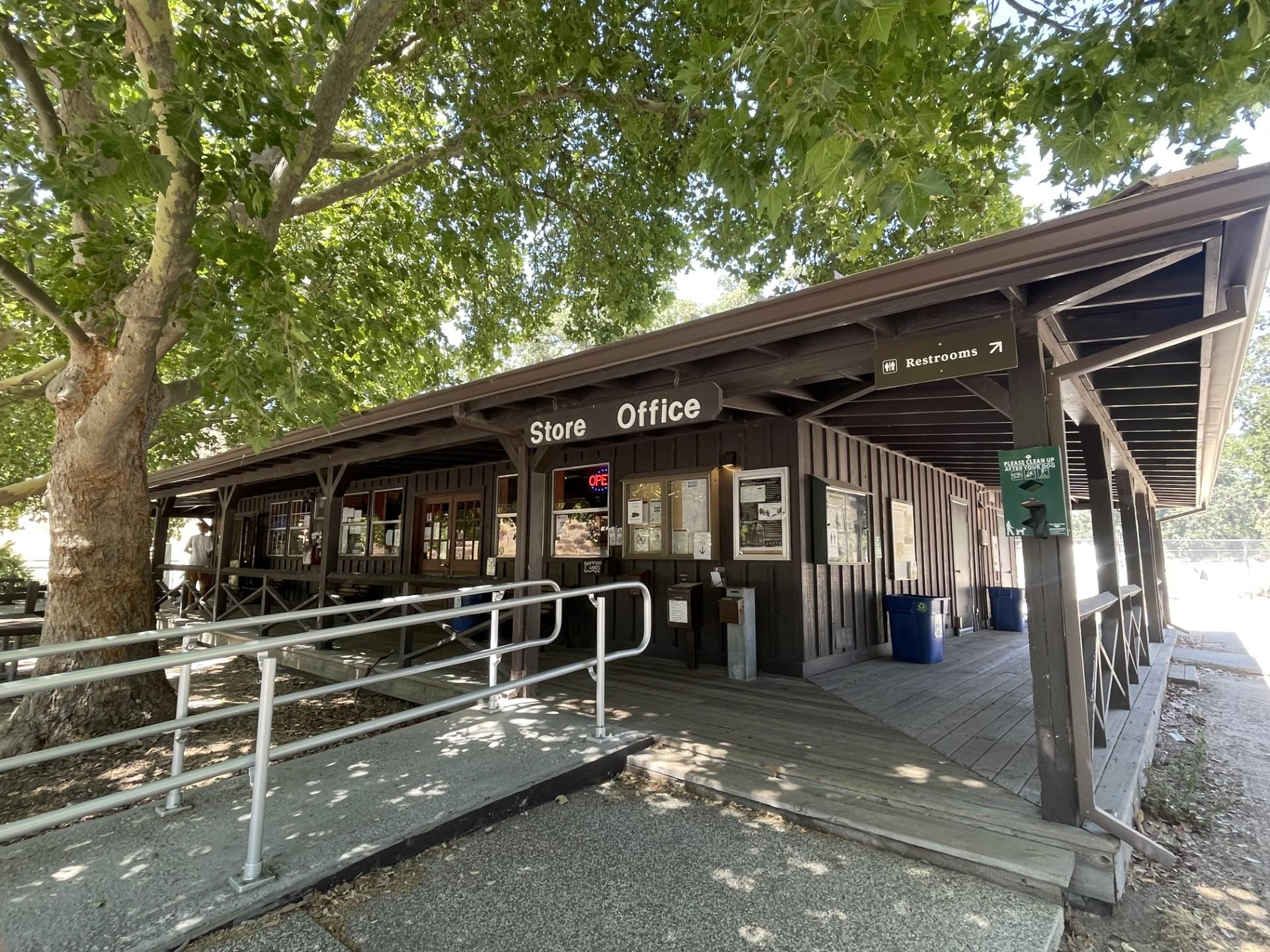 Ramp onto a wooden wrap around deck of a campground store