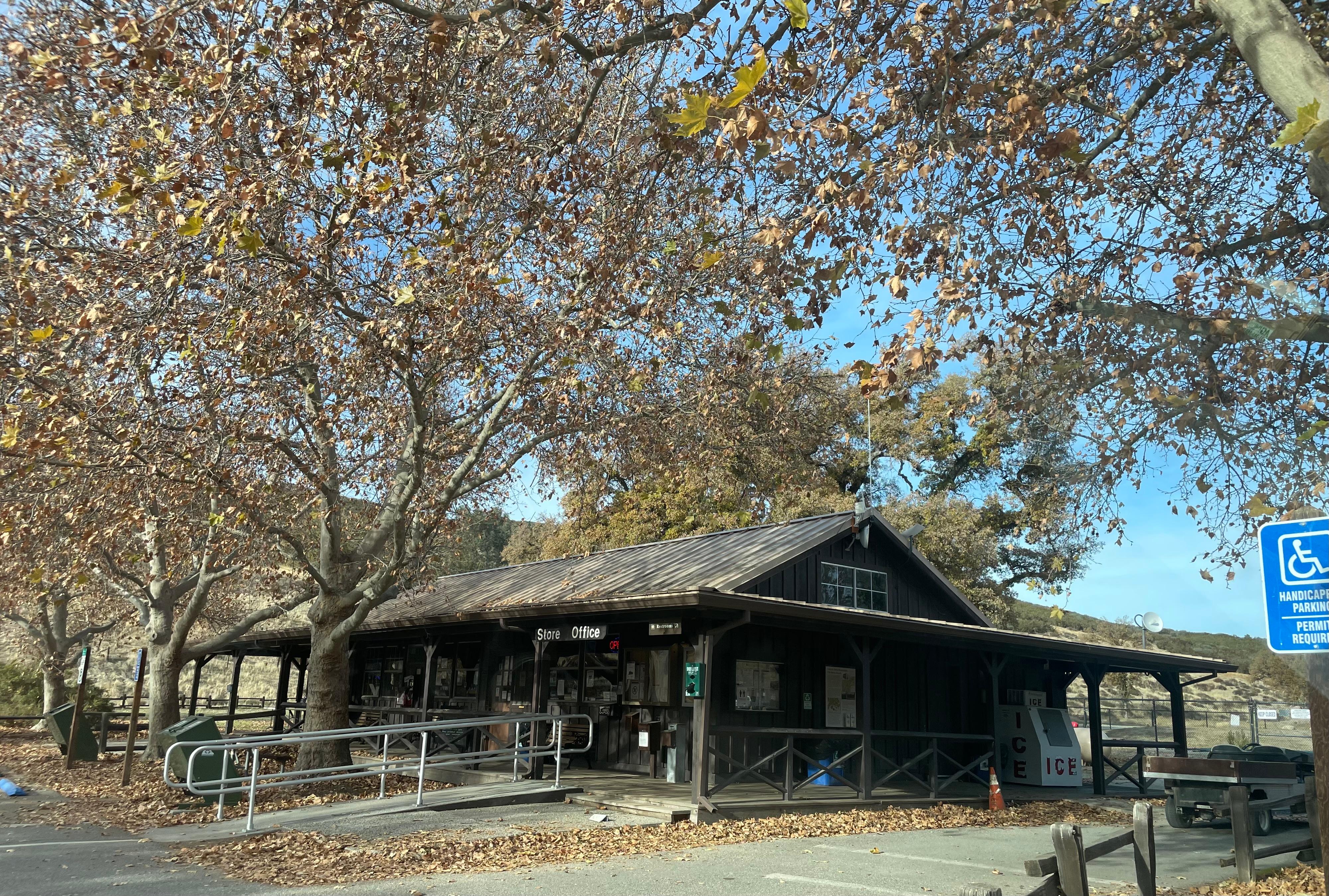 Wooden structure with a ramp leading to a wrap around deck in early winter