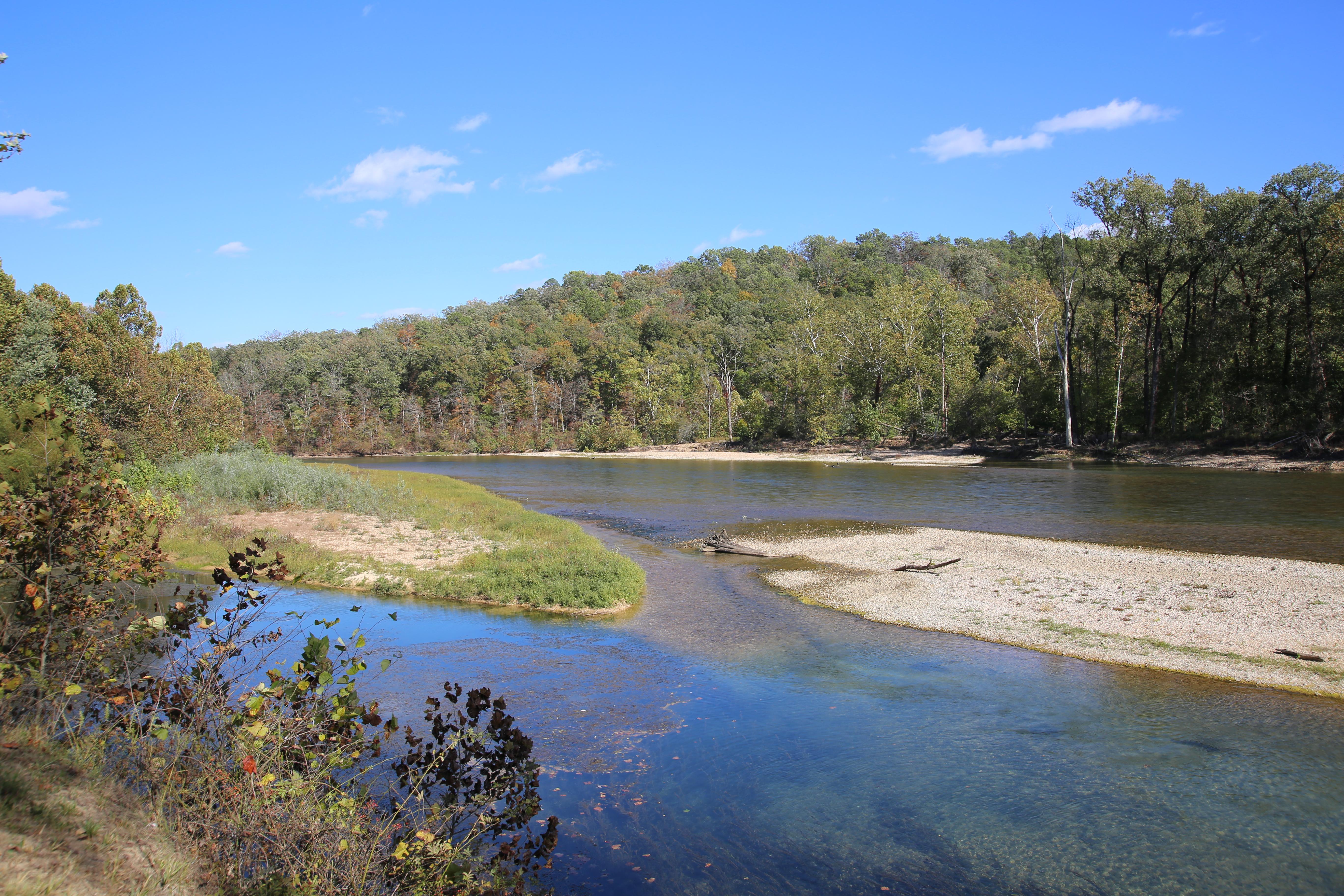 A large river mixes with a small inlet.