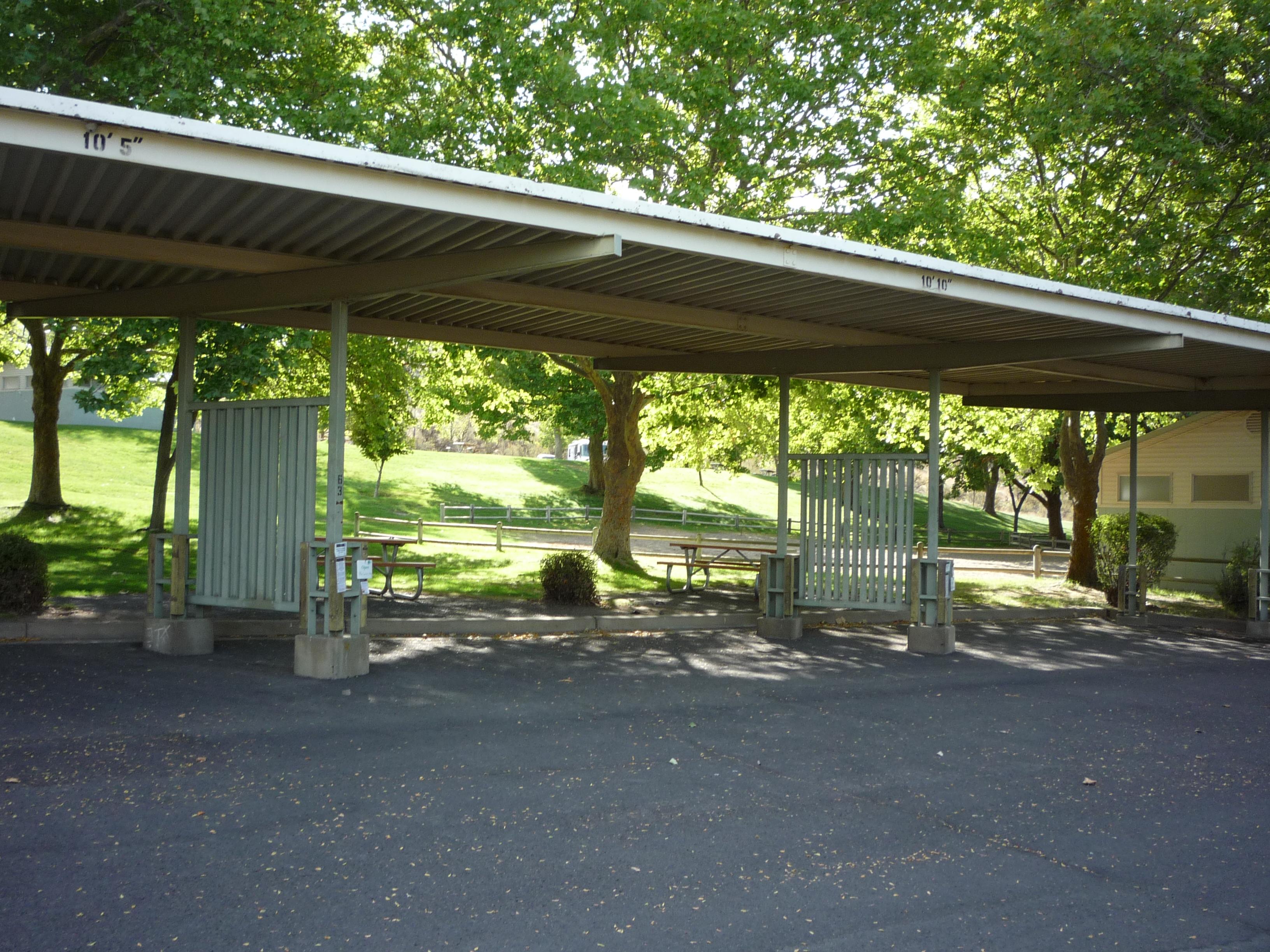 A paved and sheltered campsite area adjacent to the bathrooms.